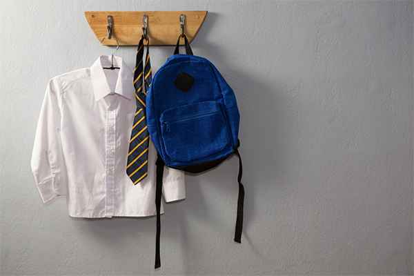 School uniform and bag hanging on hook